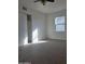 Bedroom featuring neutral carpet, window, and freshly painted white walls and closet at 2324 W Luke Ave, Phoenix, AZ 85015