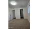 Bedroom featuring neutral carpet, and freshly painted white walls with view to another room at 2324 W Luke Ave, Phoenix, AZ 85015