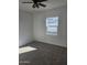 Cozy bedroom with neutral carpet, window, and freshly painted white walls at 2324 W Luke Ave, Phoenix, AZ 85015