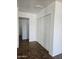 Hallway with closet and dark tile floors at 2324 W Luke Ave, Phoenix, AZ 85015