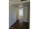 Hallway with tile floors, storage and view of carpeted room and bright window at 2324 W Luke Ave, Phoenix, AZ 85015