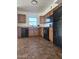 A functional kitchen featuring modern black appliances and wooden cabinetry at 2324 W Luke Ave, Phoenix, AZ 85015