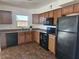 Well-designed kitchen with modern black appliances and wood cabinets at 2324 W Luke Ave, Phoenix, AZ 85015