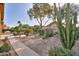 Pathway through backyard with desert plants and patio furniture at 2409 E Antigua Dr, Casa Grande, AZ 85194