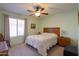 Cozy bedroom with ceiling fan, wood furniture and window coverings at 2409 E Antigua Dr, Casa Grande, AZ 85194