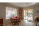 Cozy dining area with a wooden table and sliding door access to patio at 2409 E Antigua Dr, Casa Grande, AZ 85194