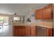 Kitchen features a breakfast bar, stainless steel dishwasher, and view to backyard at 2409 E Antigua Dr, Casa Grande, AZ 85194