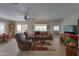 Living area with tiled floors, brown couch, and a fireplace at 2409 E Antigua Dr, Casa Grande, AZ 85194