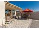 Backyard patio with seating area, umbrella, and artificial turf at 2427 W Kowalsky Ln, Phoenix, AZ 85041