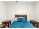 Bedroom with teal bedding and two wooden nightstands at 2427 W Kowalsky Ln, Phoenix, AZ 85041