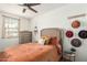 Bedroom with orange bedding and rustic decor at 2427 W Kowalsky Ln, Phoenix, AZ 85041