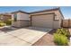 House exterior showcasing a two-car garage and well-manicured landscaping at 2427 W Kowalsky Ln, Phoenix, AZ 85041