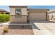 Exterior view of home with tan garage door and landscaping at 2427 W Kowalsky Ln, Phoenix, AZ 85041