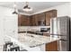 Modern kitchen featuring granite countertops and ample cabinet space at 2427 W Kowalsky Ln, Phoenix, AZ 85041