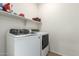 Laundry room with washer, dryer, and overhead shelving at 2427 W Kowalsky Ln, Phoenix, AZ 85041