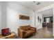 Cozy living room featuring a brown leather couch at 2427 W Kowalsky Ln, Phoenix, AZ 85041