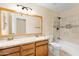 Bathroom with double vanity, large mirror, and shower/tub at 2715 S Rita Ln, Tempe, AZ 85282