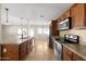 Open concept kitchen with island and wood cabinets at 2715 S Rita Ln, Tempe, AZ 85282