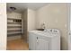 Bright laundry room with washer, dryer, and shelving at 2715 S Rita Ln, Tempe, AZ 85282