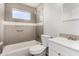 Updated bathroom featuring a tiled shower-over-bath and modern vanity, offering a blend of style and functionality at 2906 W Alice Ave, Phoenix, AZ 85051