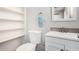 Bright bathroom featuring a modern vanity, updated fixtures, and convenient built-in shelving for optimal storage at 2906 W Alice Ave, Phoenix, AZ 85051