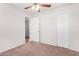 Bedroom featuring neutral walls, carpet flooring, closet and a ceiling fan, creating a relaxing and inviting space at 2906 W Alice Ave, Phoenix, AZ 85051