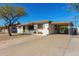 Charming single-story home features a carport, desert landscaping and neutral paint at 2906 W Alice Ave, Phoenix, AZ 85051