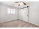 Main bedroom with carpet flooring, neutral paint and a sliding barn door at 2906 W Alice Ave, Phoenix, AZ 85051