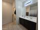 Double vanity bathroom with dark cabinets and a separate toilet area at 3014 N Majestic Ct, Casa Grande, AZ 85122