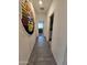 Hallway with wood-look tile floors leading to bedrooms and laundry room at 3014 N Majestic Ct, Casa Grande, AZ 85122