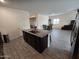 Open kitchen with island, granite countertops, and views to dining area at 3014 N Majestic Ct, Casa Grande, AZ 85122