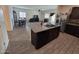 Open concept kitchen with island and adjacent dining and living areas at 3014 N Majestic Ct, Casa Grande, AZ 85122