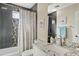 Stylish bathroom with a shower-tub combination and a white vanity with granite countertop and a decorative mirror at 3021 E Agritopia N Loop, Gilbert, AZ 85296