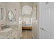 Bathroom with a granite countertop and arched doorway into the bedroom at 3021 E Agritopia N Loop, Gilbert, AZ 85296