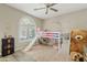 Bedroom with a bunkbed, ceiling fan, and arch window with shutters at 3021 E Agritopia N Loop, Gilbert, AZ 85296