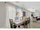 Bright dining room with a wooden table, chandelier, and view of the outdoors at 3021 E Agritopia N Loop, Gilbert, AZ 85296