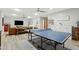 Spacious game room with ping pong table, tv and comfortable leather sofa at 3021 E Agritopia N Loop, Gilbert, AZ 85296