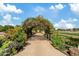 Picturesque garden path under an archway of vines and flowers leading through a vibrant landscape at 3021 E Agritopia N Loop, Gilbert, AZ 85296