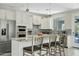 Modern kitchen with white cabinetry, stainless steel appliances, and a stylish backsplash at 3021 E Agritopia N Loop, Gilbert, AZ 85296