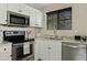 This kitchen features white cabinetry and stainless steel appliances at 3021 E Agritopia N Loop, Gilbert, AZ 85296