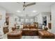 Open-concept living room with a leather sectional sofa and ping pong table in the background at 3021 E Agritopia N Loop, Gilbert, AZ 85296