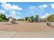 Community playground with climbing structures, slides, and swings, set in a sandy play area on a bright day at 3021 E Agritopia N Loop, Gilbert, AZ 85296