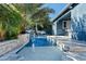 Backyard view of the swimming pool with water feature, lush greenery, and patio with outdoor seating at 3021 E Agritopia N Loop, Gilbert, AZ 85296