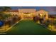 Luxury backyard oasis with putting green, lighting, and covered patio at 30416 N 64Th St, Cave Creek, AZ 85331