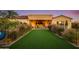 Landscaped backyard with putting green and view of the home at 30416 N 64Th St, Cave Creek, AZ 85331