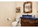 Bathroom with antique vanity, blue tile, and decorative mirror at 30416 N 64Th St, Cave Creek, AZ 85331