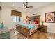 Bright bedroom with rustic bed and cowhide rug at 30416 N 64Th St, Cave Creek, AZ 85331