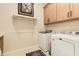 Laundry room with washer, dryer, and cabinets at 30416 N 64Th St, Cave Creek, AZ 85331