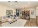 Living room with comfortable seating, large artwork, and wooden display cabinet at 30416 N 64Th St, Cave Creek, AZ 85331