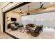 Covered patio with wicker furniture, rug, and view of pool and desert landscape at 30416 N 64Th St, Cave Creek, AZ 85331